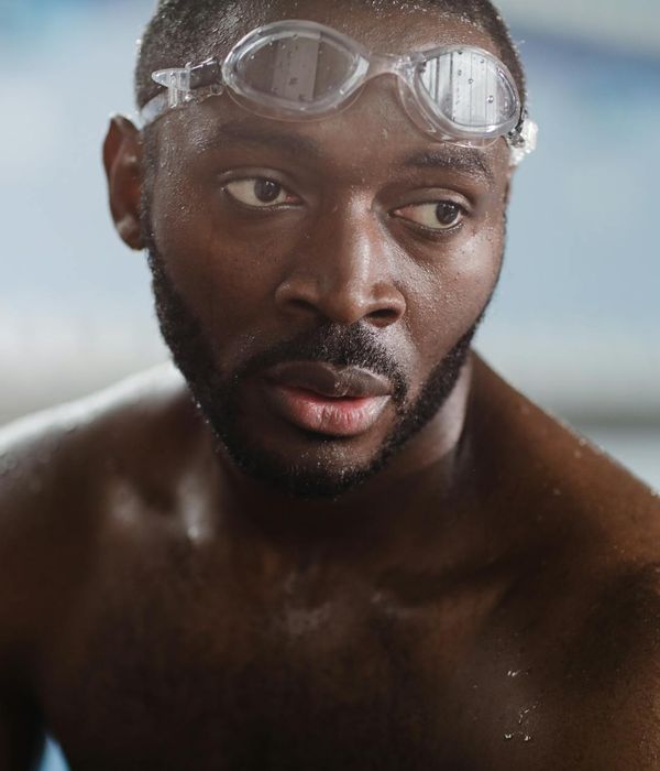 Strong man performing morning energy exercises in a modern room